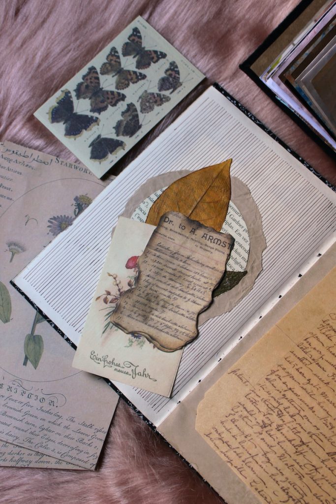 a table topped with lots of old papers